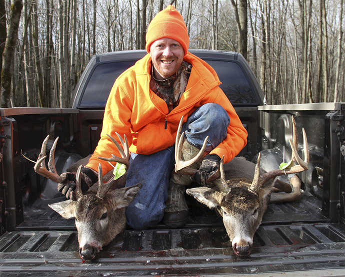 hunter making picture with two hunted deer
